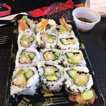 Edo Japan - a tray of sushi with a person holding a cell phone - Japanese Near Me - Kamloops, British Columbia Edo Japan - a tray of sushi with a person holding a cell phone - Japanese Near Me - Kamloops, British Columbia