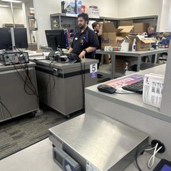 FedEx Office Print & Ship Center - View of employee work area from the customer service area.