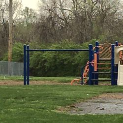 Livingston - Wright Park - An old, A-frame swing set stands next to this more modern climbing structure.