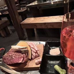 a plate of meat and a glass of wine a plate of meat and a glass of wine