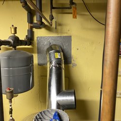 Ultimate Chimney & Masonry - Furnace pipe going into lining system with a high temperature cement to seal up wall