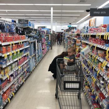 Walgreens - a woman pushing a shopping cart through a store aisle - Drugstores Near Me - Kissimmee, Florida Walgreens - a woman pushing a shopping cart through a store aisle - Drugstores Near Me - Kissimmee, Florida