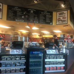 Jimmy John's - Employee sitting on the food counter. Who does that?! Gross.