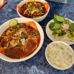 three bowls of soup on a table