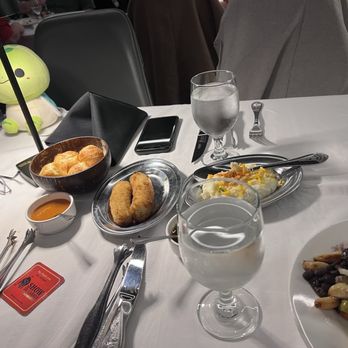 Show de Carnes - Our table with the side dishes of cheese bread, fried banana, and mash potatoes. - Steakhouses Near Me - Sausalito, California Show de Carnes - Our table with the side dishes of cheese bread, fried banana, and mash potatoes. - Steakhouses Near Me - Sausalito, California