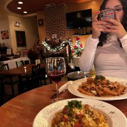 a woman taking a picture of her meal