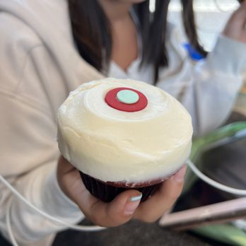 Sprinkles ATM - a woman holding a cupcake - Cupcakes Near Me - Austin, Texas Sprinkles ATM - a woman holding a cupcake - Cupcakes Near Me - Austin, Texas