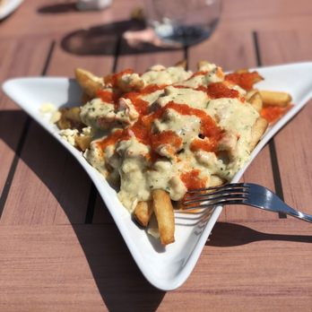 Tipsy Tails - Lobster poutine - delicious! Real chunks of lobster smothered in a creamy gravy sauce - Seafood Near Me