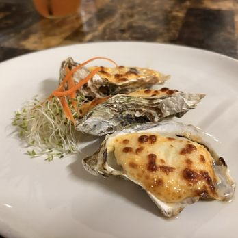 Tiny Pyramid - My appetizer. Baked oysters. The cheese was cooked but the oyster underneath is served fresh and raw. - Cafes Near Me - Honolulu, Hawaii