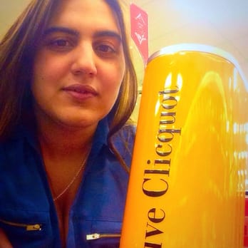 ABC Fine Wine & Spirits - a woman holding a bottle of wine - Beer, Wine & Spirits Near Me - Miami, Florida