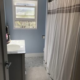 New floor tile, baseboards, vanity, and paint
