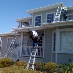 Nefi is on the upper level and Juan is on the lower level. They tear off the damaged wood and replace with new pressure-treated wood.