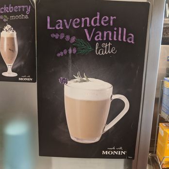 The Good Bean - Unique flavors! Very extensive menu with reasonable prices for a cute coffee shop like this!  Fresh coffee, free wi-fi, and kind service! - A black chalkboard sign displays a lavender vanilla latte with illustrations of lavender sprigs, promoting the drink at a coffee shop. - Coffee & Tea Near Me - Dover, New Jersey