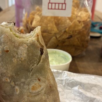 The Taco Stand - Carne asada burrito and my bag of tortilla chips in the background. - Mexican Near Me - Costa Mesa, California The Taco Stand - Carne asada burrito and my bag of tortilla chips in the background. - Mexican Near Me - Costa Mesa, California