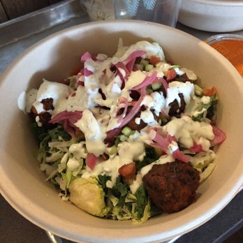 CAVA - Grains and greens bowl with superfood greens, falafel, black lentils, red onion, tomato, cucumber, and yogurt dill sauce. - Mediterranean Near Me - Gaithersburg, Maryland CAVA - Grains and greens bowl with superfood greens, falafel, black lentils, red onion, tomato, cucumber, and yogurt dill sauce. - Mediterranean Near Me - Gaithersburg, Maryland