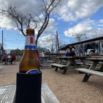 Scotty's Saloon at OTP - a beer bottle on a picnic table - Sports Bars Near Me - Richmond, Texas