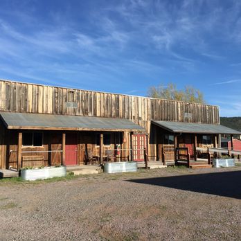 Trapper's Rendezvous - The front of some of the rooms in front of the blue Arizona sky - Bed & Breakfast Near Me - Williams, Arizona