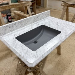 Poney's Custom Laminate Surfaces - Formica's Carrara Bianco in an Etchings finish with an 1 1/4 ideal edge. It has a Karran, Gray under mounted sink bowl.
