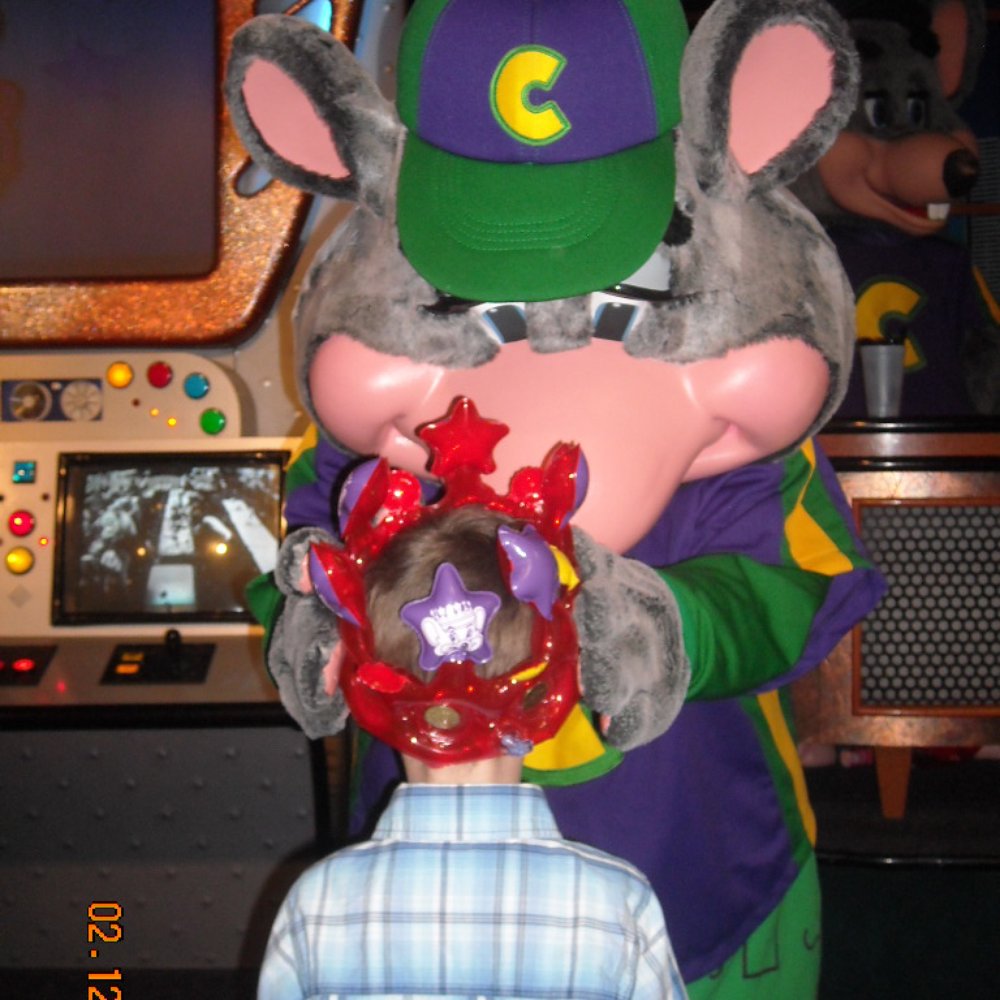 Chuck E. Cheese - Chuck E Cheese crowning the birthday child - Pizza Near Me - Bakersfield, California Chuck E. Cheese - Chuck E Cheese crowning the birthday child - Pizza Near Me - Bakersfield, California