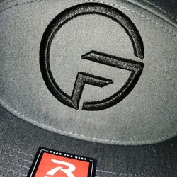 Stitched Industries - Top of the logo touching the stitching of the hat
