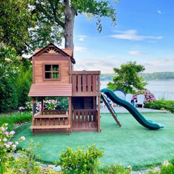 Creative Playthings - A wooden residential swing set in a tropical setting from Creative Playthings.