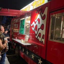 people standing in line at a food truck
