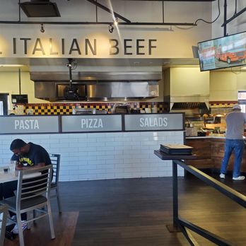 Buona - a man working in a restaurant - Pizza Near Me - Hillside, Illinois