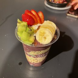 a fruit smoothie in a plastic cup