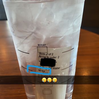Starbucks - a plastic cup with a plastic lid on a wooden table - Coffee & Tea Near Me - Miramar Beach, Florida Starbucks - a plastic cup with a plastic lid on a wooden table - Coffee & Tea Near Me - Miramar Beach, Florida