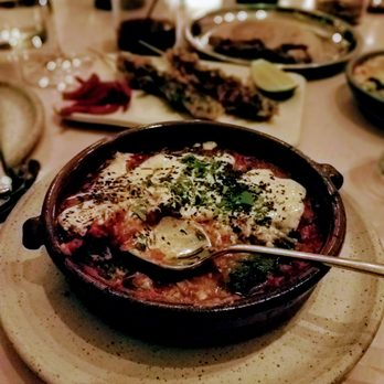 Tusk - Halloumi cheese baked with spicy tomato, greens, yogurt, and nigella seeds at Tusk - Middle Eastern Near Me - Portland, Oregon Tusk - Halloumi cheese baked with spicy tomato, greens, yogurt, and nigella seeds at Tusk - Middle Eastern Near Me - Portland, Oregon