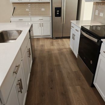 Rainbow Cleaning Services - Modern residential kitchen with white cabinets, stainless steel refrigerator, dishwasher, and sink... - Home Cleaning Near Me - Summerville, South Carolina Rainbow Cleaning Services - Modern residential kitchen with white cabinets, stainless steel refrigerator, dishwasher, and sink... - Home Cleaning Near Me - Summerville, South Carolina