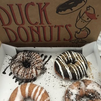 Duck Donuts - Top row (left to right): cookies and cream, s'mores Bottom row (left to right): cinnamon bun, the boardwalk - Donuts Near Me - Mamaroneck, New York Duck Donuts - Top row (left to right): cookies and cream, s'mores Bottom row (left to right): cinnamon bun, the boardwalk - Donuts Near Me - Mamaroneck, New York