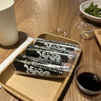 Hand Roll Factory - Hand rolls in their wrappers separating the nori from the rice. - Sushi Bars Near Me - Emeryville, California Hand Roll Factory - Hand rolls in their wrappers separating the nori from the rice. - Sushi Bars Near Me - Emeryville, California