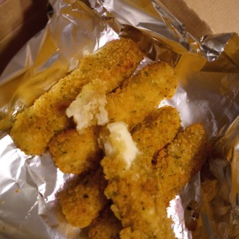 Fox's Pizza Den - a close up of a piece of breaded fish - Pizza Near Me - Clarion, Pennsylvania Fox's Pizza Den - a close up of a piece of breaded fish - Pizza Near Me - Clarion, Pennsylvania