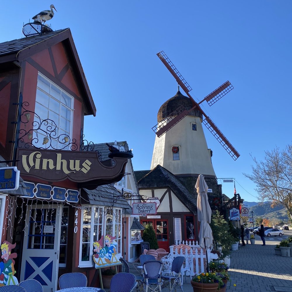 Vinhus - a windmill in the background with tables and chairs in the foreground - Beer, Wine & Spirits Near Me - Solvang, California Vinhus - a windmill in the background with tables and chairs in the foreground - Beer, Wine & Spirits Near Me - Solvang, California