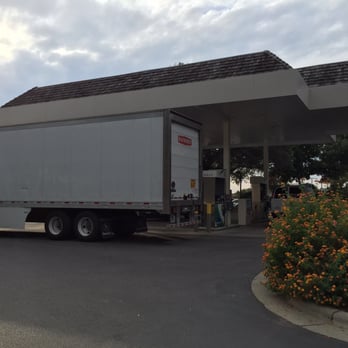 Coastal Cravings - The view of the idling truck and the gas tanks from just outside the dining area. :( - Seafood Near Me - Duck, North Carolina Coastal Cravings - The view of the idling truck and the gas tanks from just outside the dining area. :( - Seafood Near Me - Duck, North Carolina