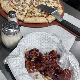 Mushroom pizza and honey barbecued wings Mushroom pizza and honey barbecued wings