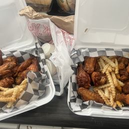 two baskets of fried chicken and french fries