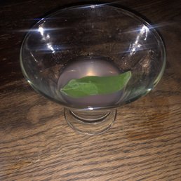 a glass bowl with a leaf in it a glass bowl with a leaf in it