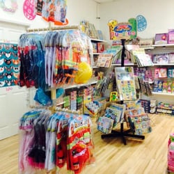 Kelekia Toys & Gifts - One side of the store featuring puzzles and costume play sets by Melissa & Doug.
