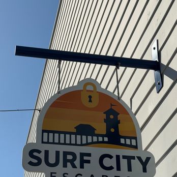 Surf City Escapes - Hanging sign by the entrance - Escape Games Near Me - Huntington Beach, California Surf City Escapes - Hanging sign by the entrance - Escape Games Near Me - Huntington Beach, California