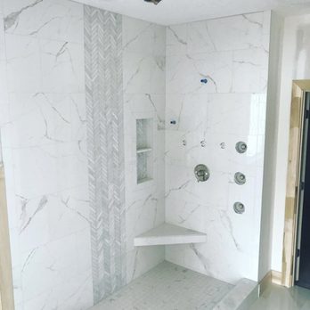 Kudrik Brothers - a walk in shower with a bench - Flooring Near Me Kudrik Brothers - a walk in shower with a bench - Flooring Near Me