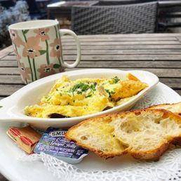 a plate of food and a cup of coffee