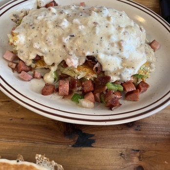 Wild Huckleberry - German sausage, ham, bacon, green peppers and onions, layered between hash browns, topped with sausage gravy. - Breakfast & Brunch Near Me - Wenatchee, Washington