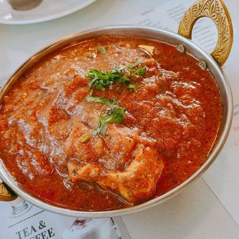 Indian Grill - a pan of food on a table - Indian Near Me - Camillus, New York