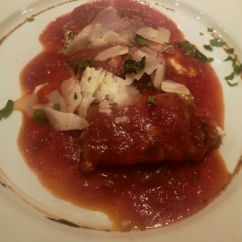 Casarecce - Eggplant Appetizer - An eggplant appetizer served on a white plate, topped with tomato sauce, grated cheese, and chopped herbs. - Italian Near Me - Boston, Massachusetts