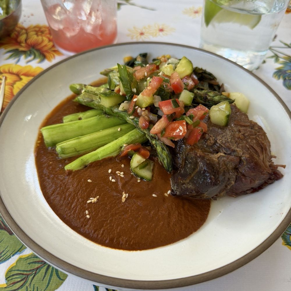 Asparagus and carnitas in mole sauce.