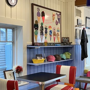 Reasons To be Cheerful - a table and chairs in a restaurant - Ice Cream & Frozen Yogurt Near Me - West Concord, Massachusetts Reasons To be Cheerful - a table and chairs in a restaurant - Ice Cream & Frozen Yogurt Near Me - West Concord, Massachusetts
