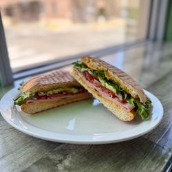 Leandro’s Cafe & Bistro - Torta Chispa with ham, melted cheese, tomato, avocado, and crisp lettuce on our freshly baked telera for a simple, satisfying bite.