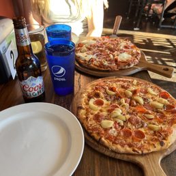 two pizzas on a table two pizzas on a table